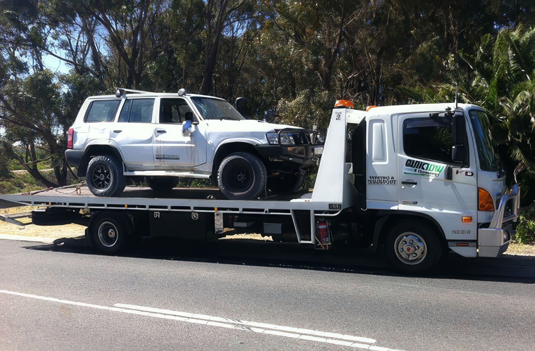 4WD loaded onto a Quik Tow tilt tray truck for recovery in Perth
